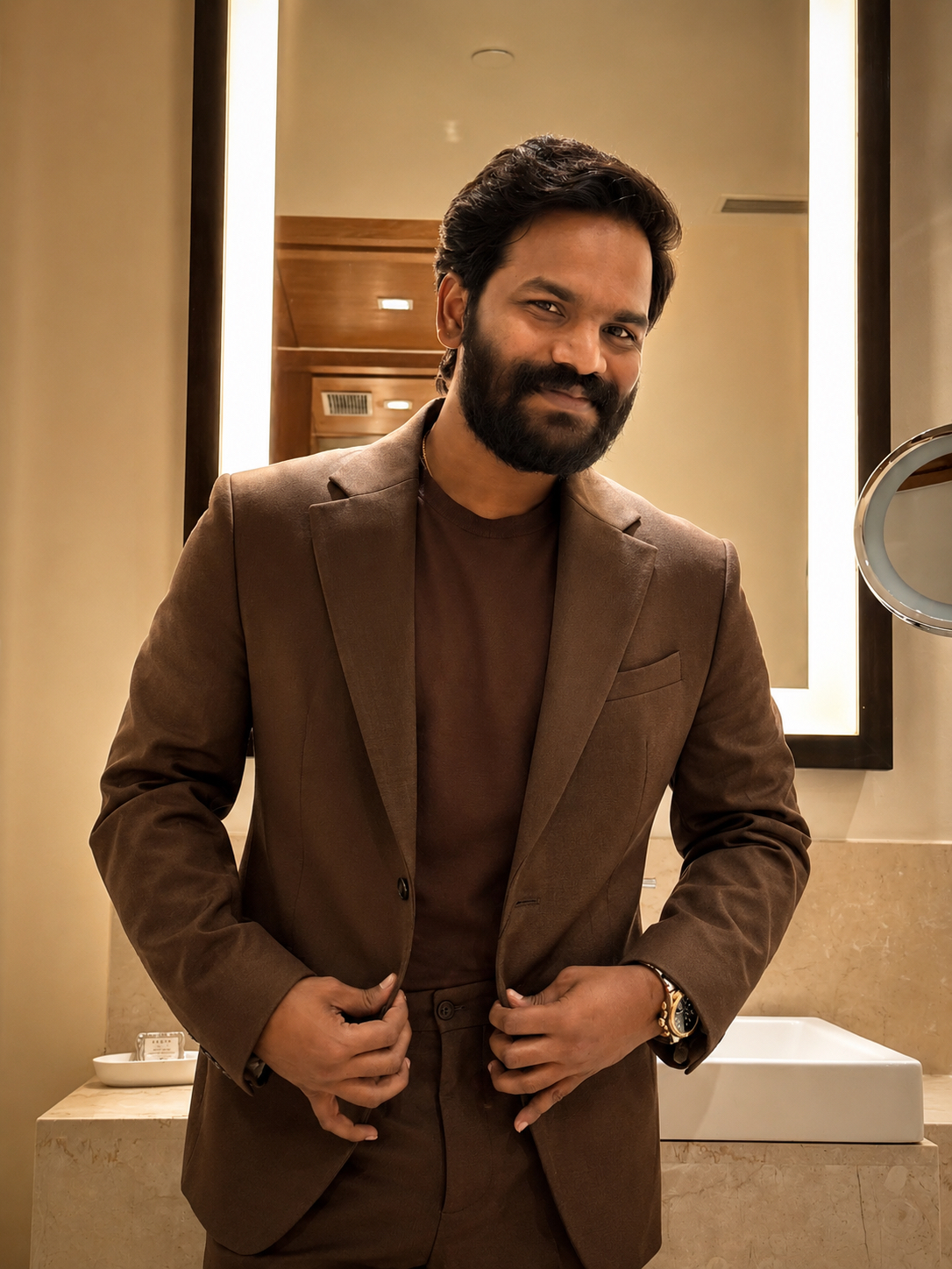 Sunkara Arjun in a tailored brown suit
